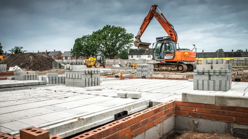 Tractor, building materials on construction site